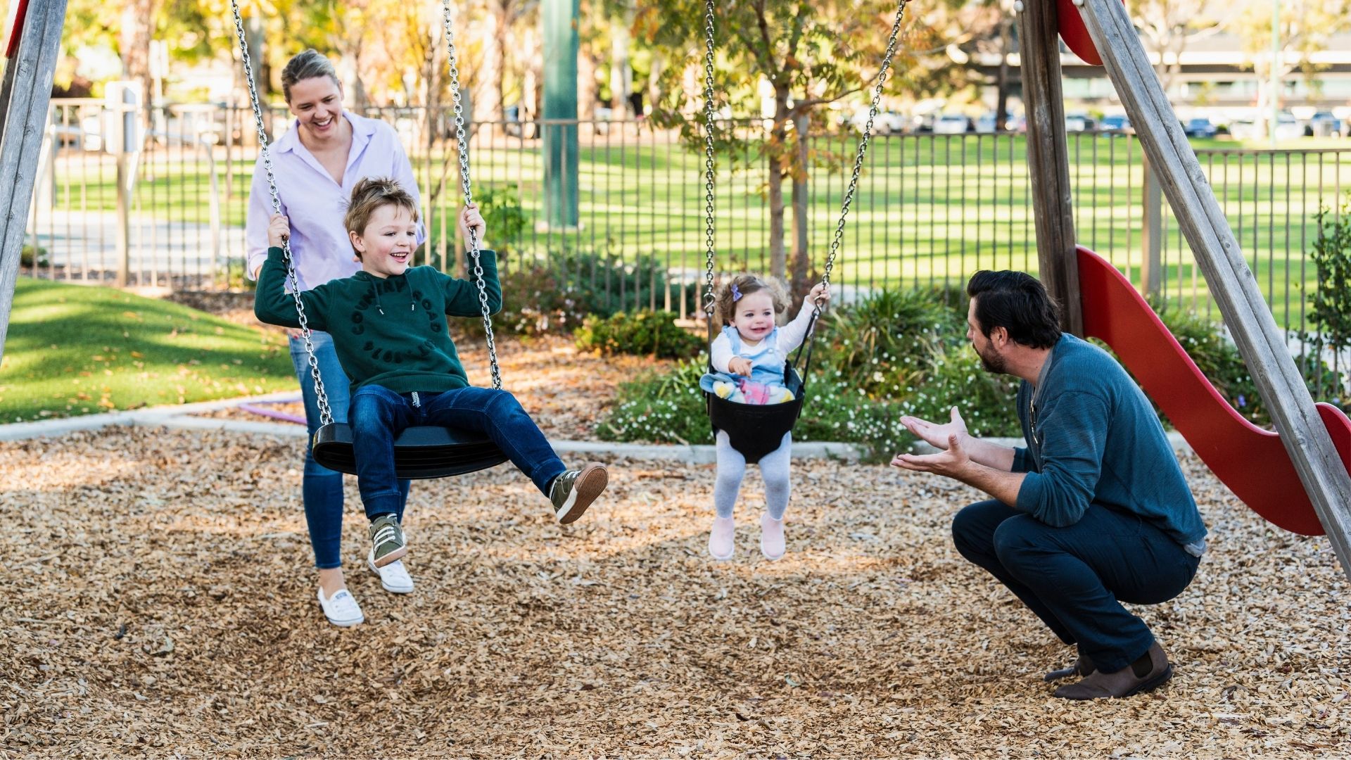family with children on swings